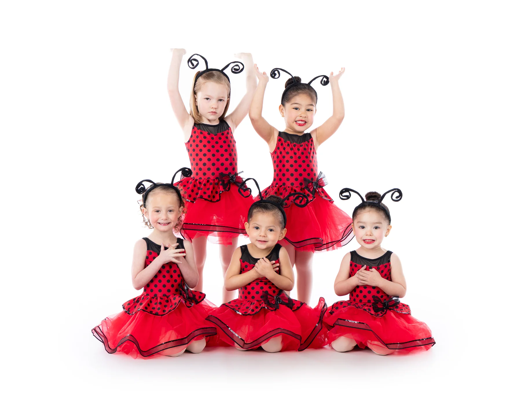 Five young Encore Academy dancers posing in red and black ladybug costumes